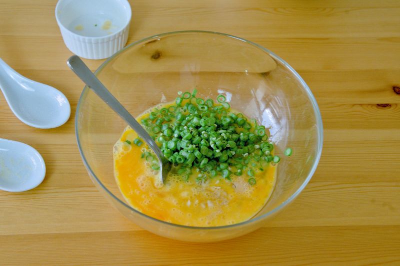 Combine the blanched green beans, preserved radish, salt, and ground white pepper with the beaten eggs thoroughly.