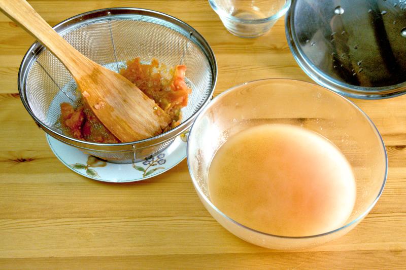 Strain the tomato mixture through a mesh strainer to obtain a clear broth.